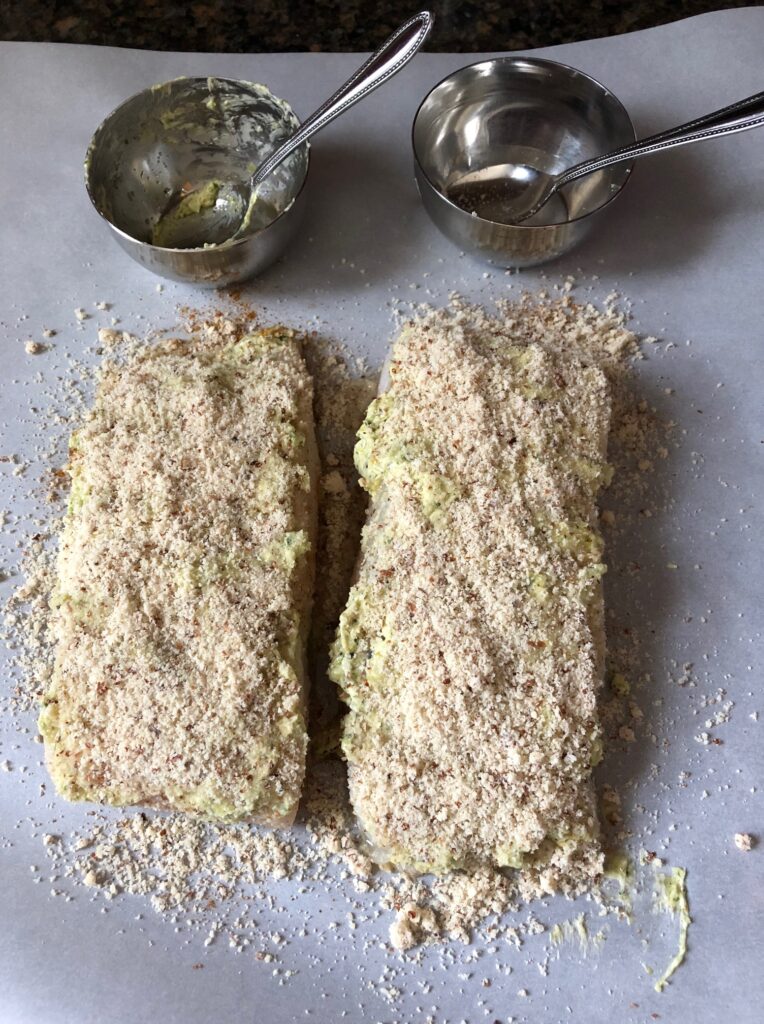 Almond Crusted halibut fish filet with garlic and herb butter