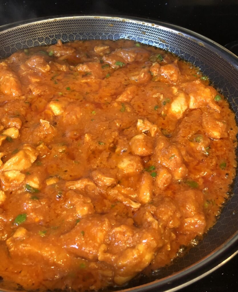 cooked chicken tikka masala in a hexclad pan