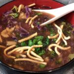 vegetarian spicy manchow soup recipe in a bowl with crispy noodles