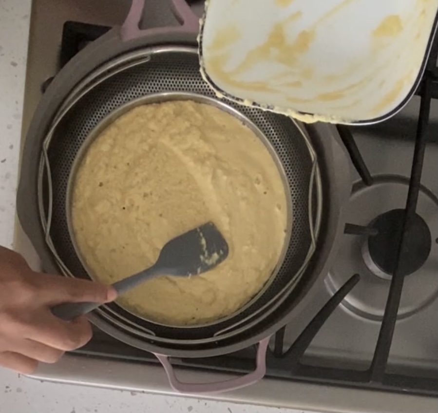 khaman batter being spred in an dhokla dish