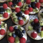 healthy pizza dessert with fruit slices and berries