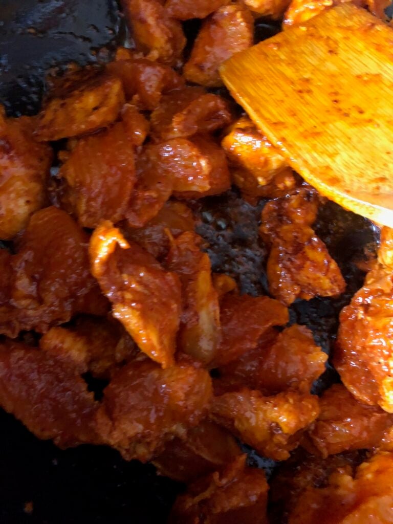 spicy chicken tikka masala in a pan with a spatula