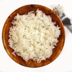 white rice fluffy cooked in an instant pot placed in a brown bowl