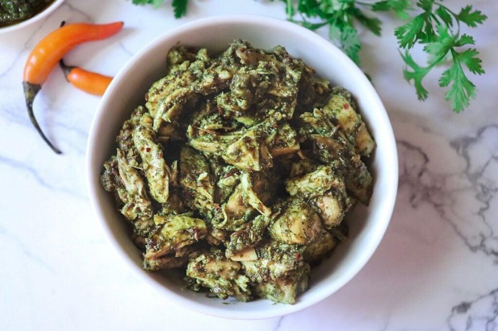 a bowl full of indian chicken with spices.