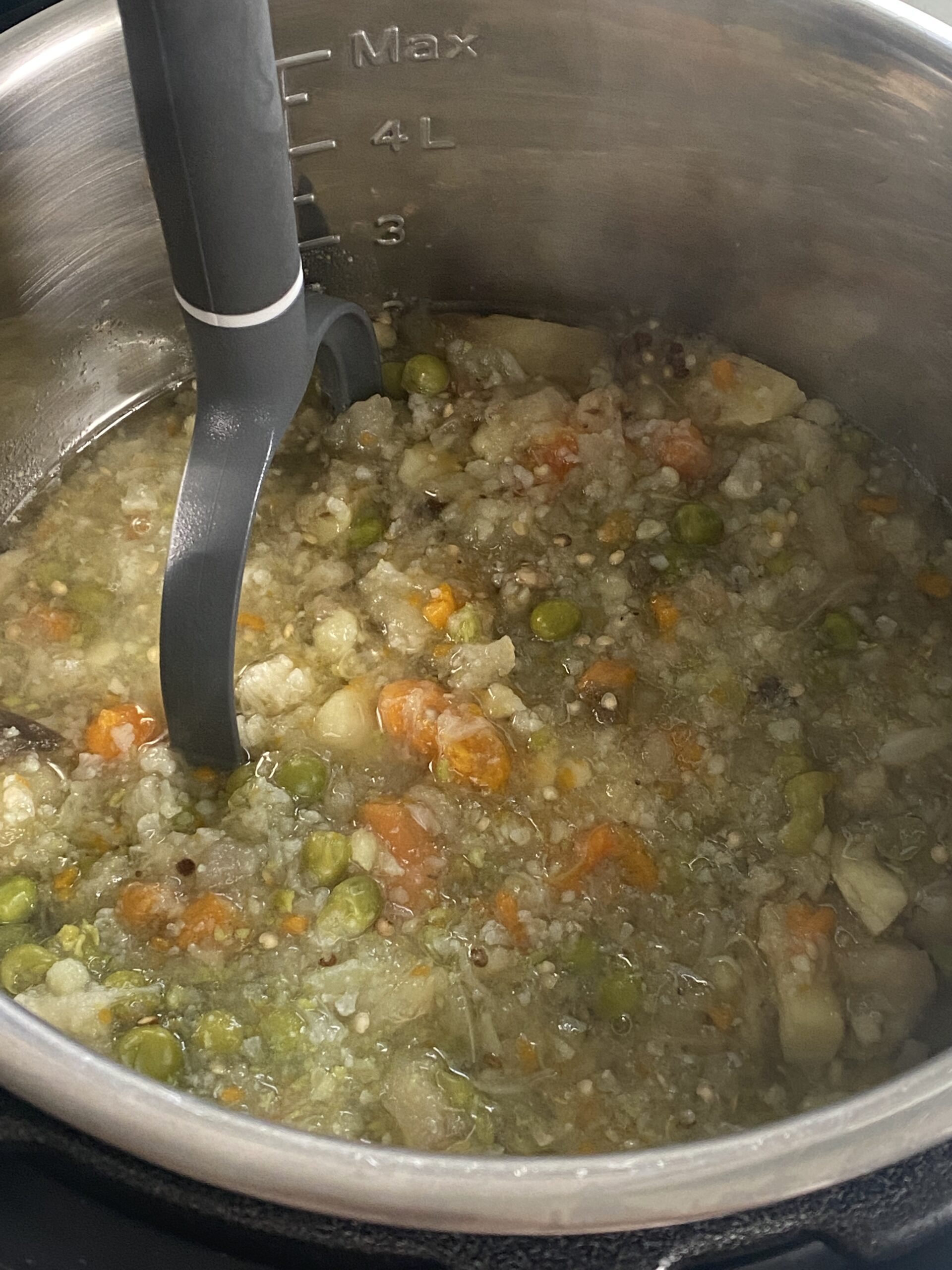 mashing the vegetables for pav bhaji