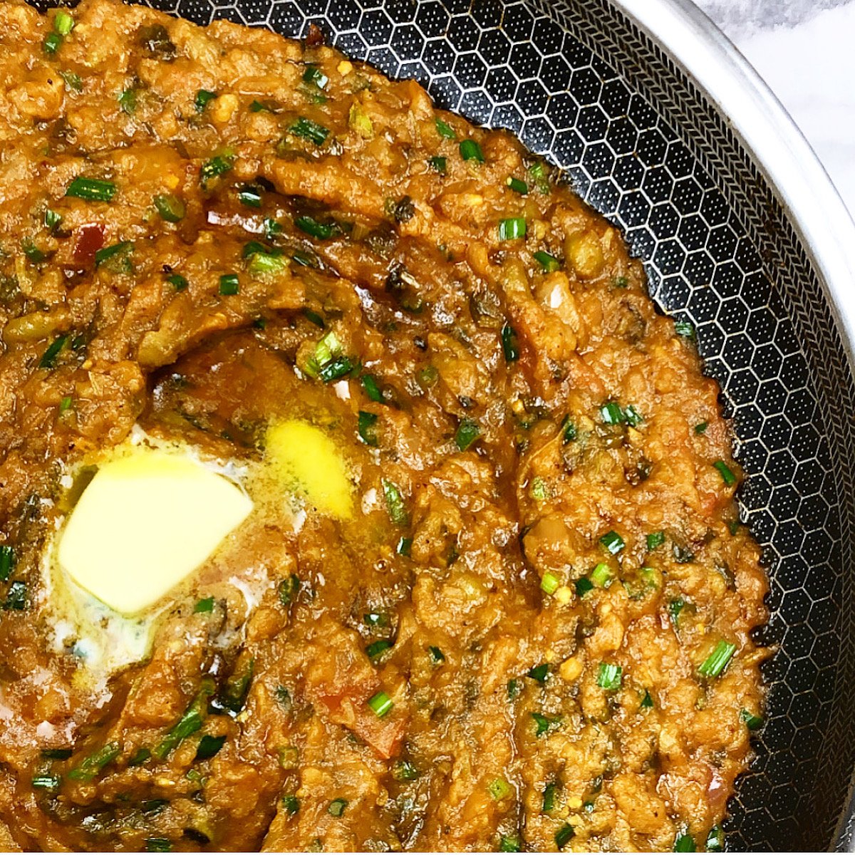 pav bhaji in a hexclad pan with butter