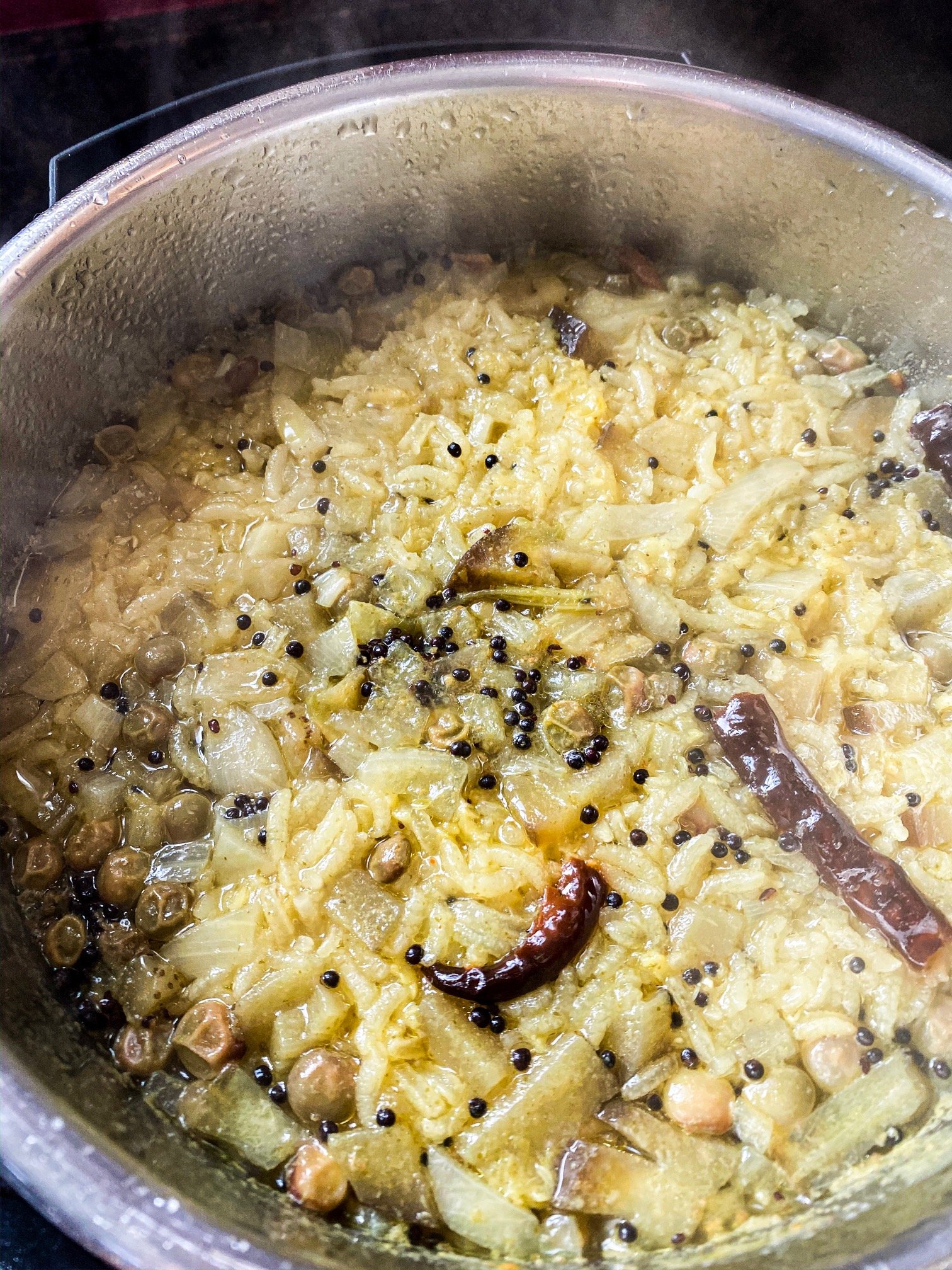 A slow cooked Gujarati porridge with rice, lentils, vegetables, and spices.