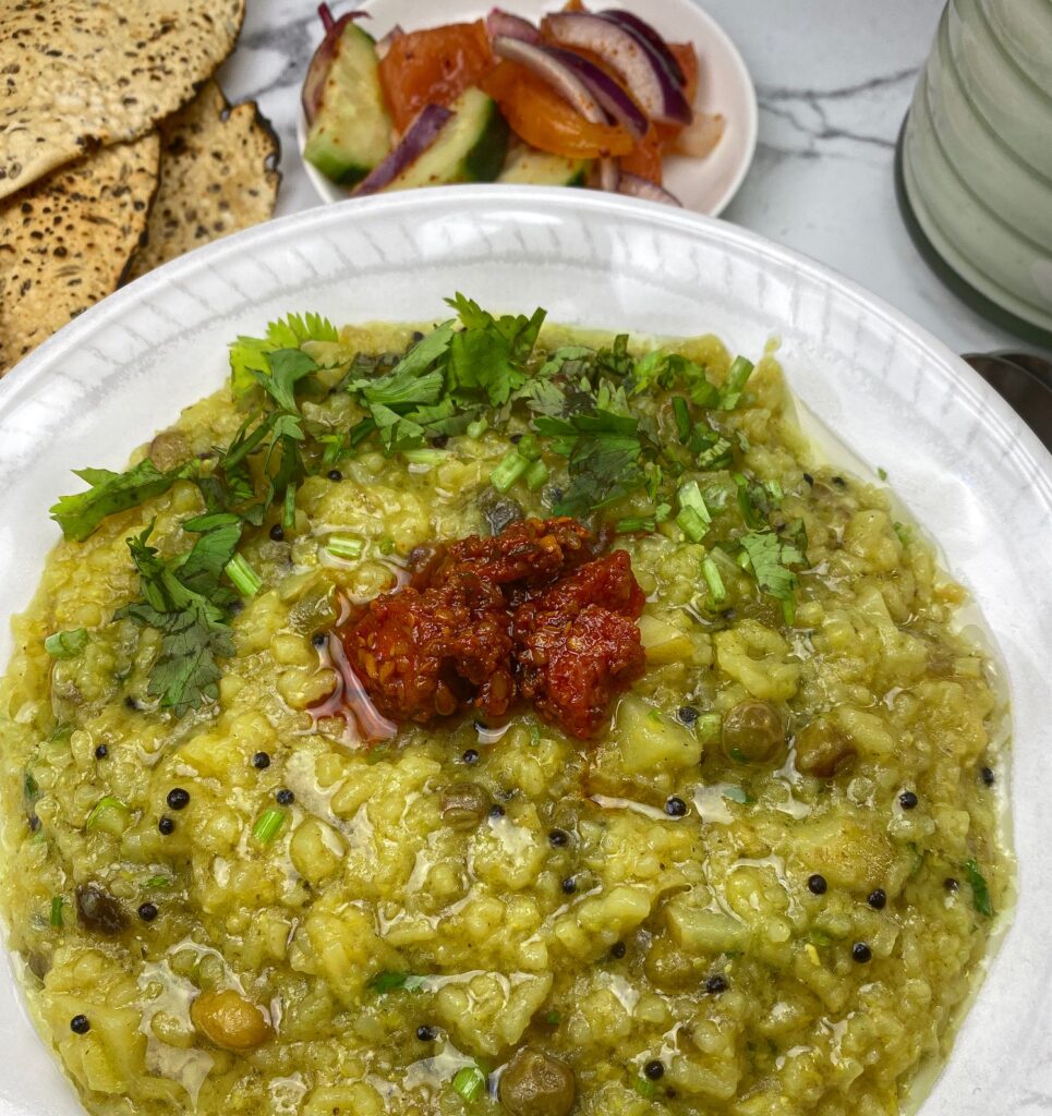 A slow cooked Gujarati porridge with rice, lentils, vegetables, and spices. 