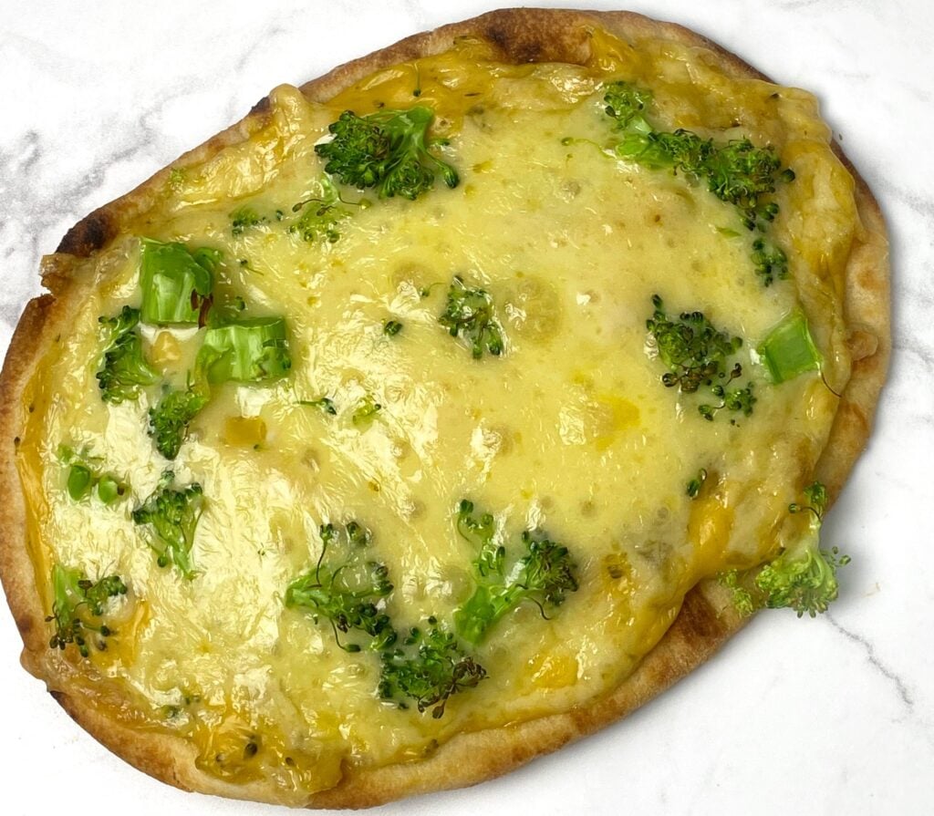 a broccoli and cheese pizza