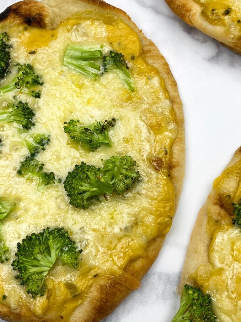 roasted broccoli on top of a naan bread