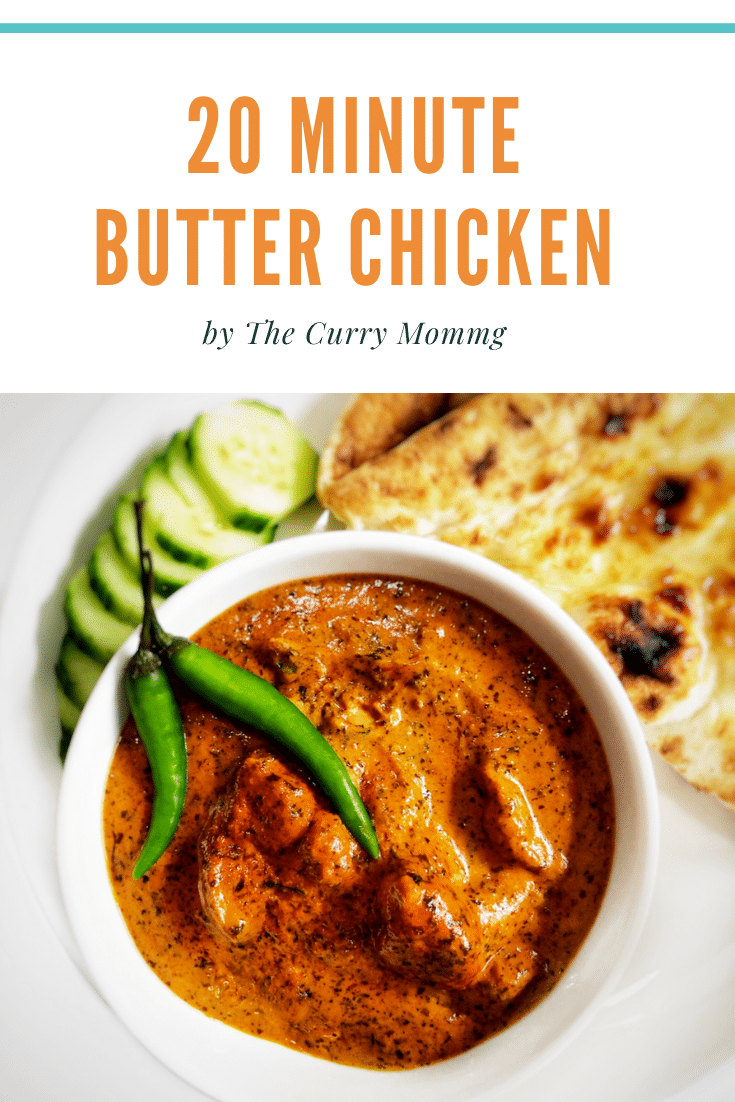 bowl of orange butter chicken with naan and cucumbers on the side