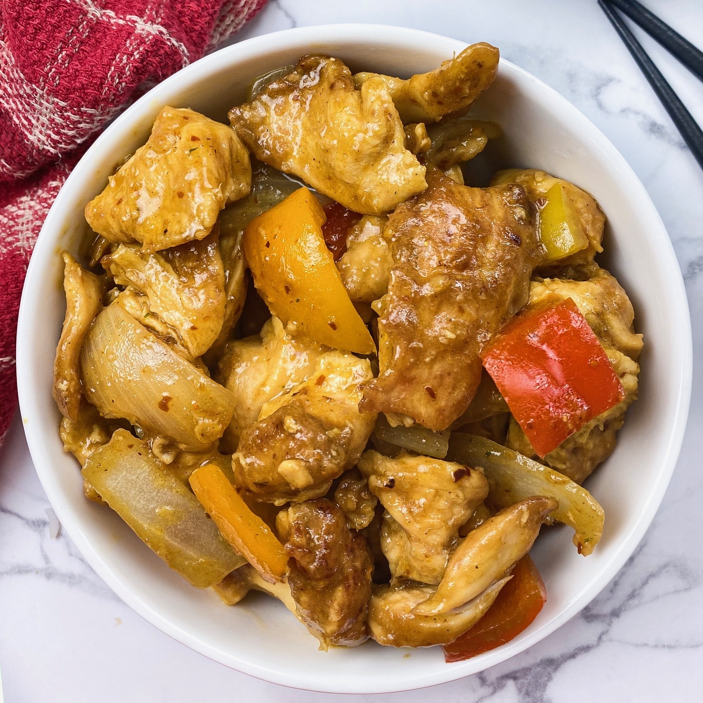 A Indo Chinese Chicken Curry dish  with curry powder and spices in a round bowl