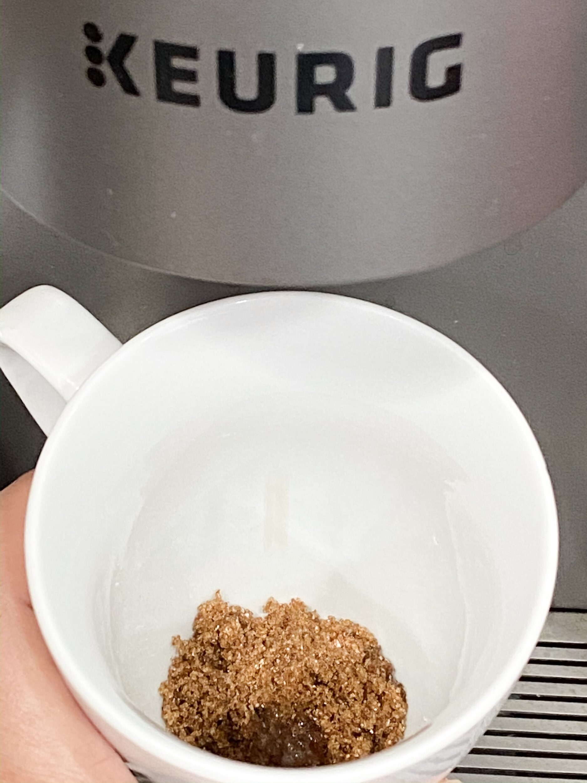 brown sugar under a coffee machine ready for espresso to be brewed on top of it