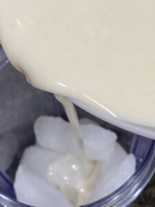 oatmilk pouring it on top of ice