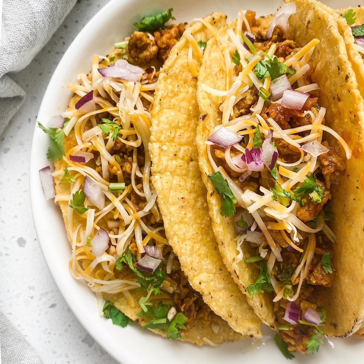 keema tacos hard on a round pate