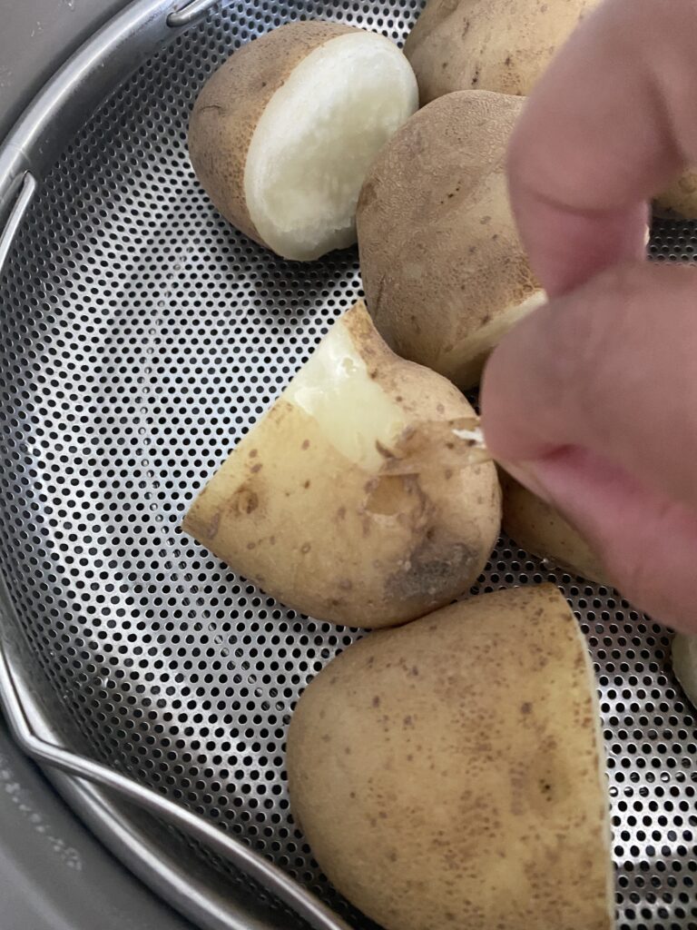 steamed potatoes with skin being removed