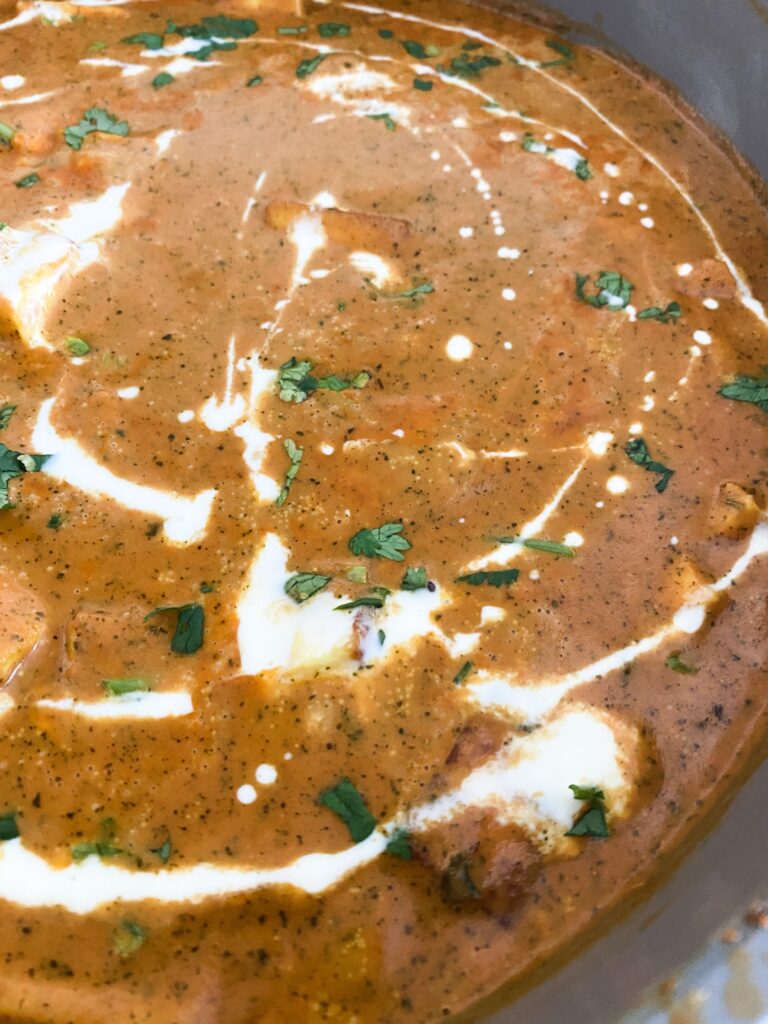 close up of an Indian curry with cream on top