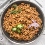 chicken kheema chicken keema recipe in a bowl with peppers, onions, and cilantro on top