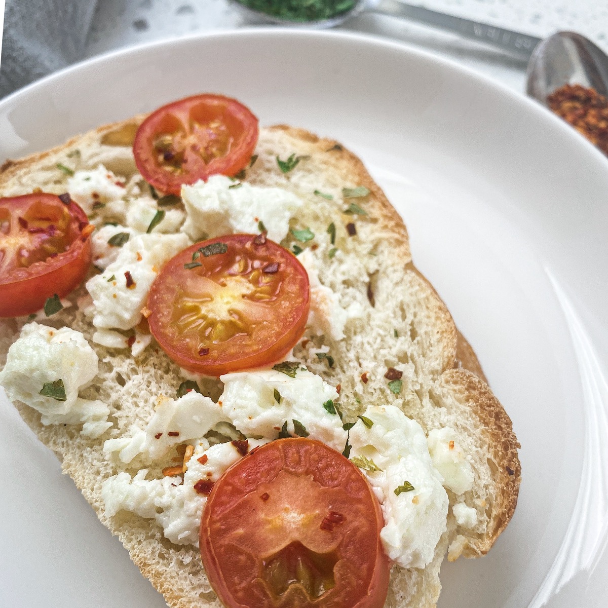 toasted french bread with mediterranean cheese and tomatoes