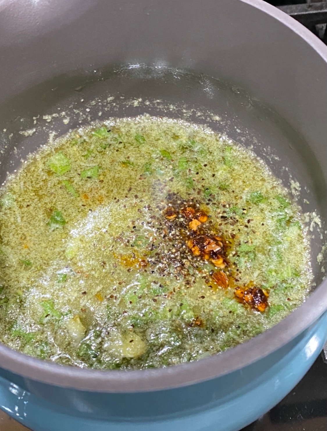 butter being cooked in a teal butter pot